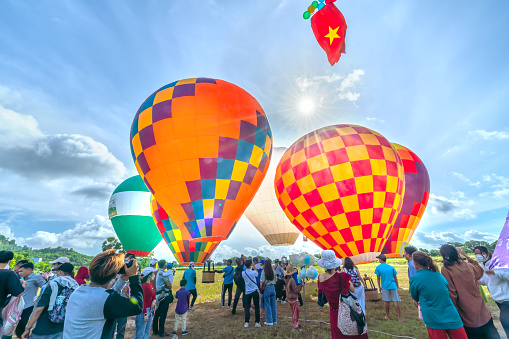 An Giang, Vietnam - September 3rd, 2022: The hot air balloon festival in Ta Pa field after the harvest attracts people to attend and watch. This is the national day celebration in An Giang, Vietnam