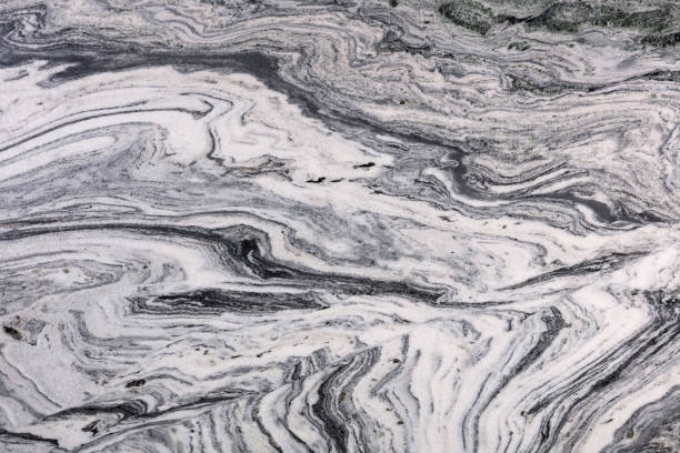 istock Volcano White, grey polished granite stone slab for perfect interior. 1422197140