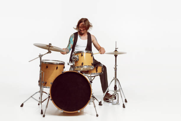 istock Portrait of young man playing drums, performing isolated over white studio background. Expression of feelings 1422199956