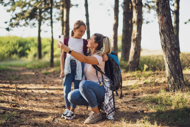 istock Mother and daughter taking selfie while hiking 1422202074