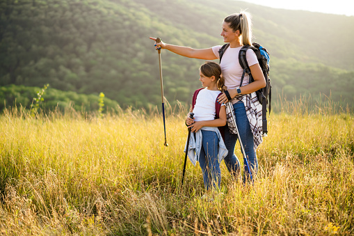 Mother and daughter enjoy hiking together.