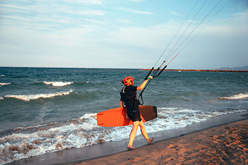 Kite surfer woman with a board