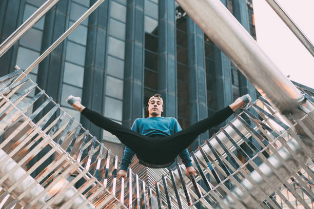 istock Happy young man doing acrobatic poses in a metal sculpture 1422206976