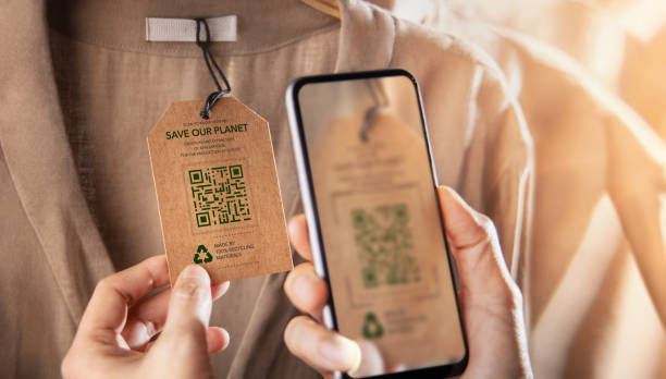 Recycling Products Concept. Organic Cotton Recycled Cloth. Zero Waste Materials. Environment Care, Reuse, Renewable for Sustainable Lifestyle. Using Mobile Phone to Scan on Tag for more Information stock photo