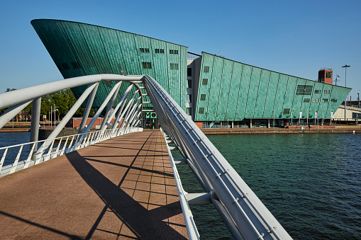 Steel walking bridge at the NEMO museum science center modern green building in Amsterdam, The Netherlands.
