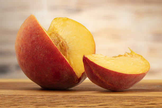 istock Sliced  peach on a wooden table. 1422210324
