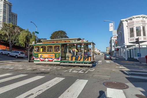 San Francisco, USA - June 6, 2022: people enjoy riding the cable car powell and Hyde Street in San Francisco, USA.