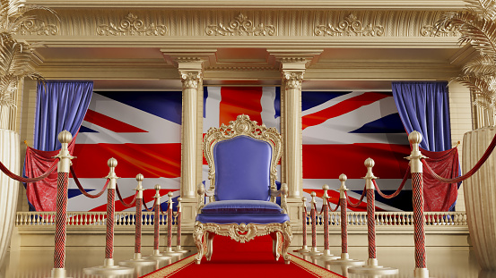 red carpet with barriers leading to the UK throne, queen throne with UK flag in the background,