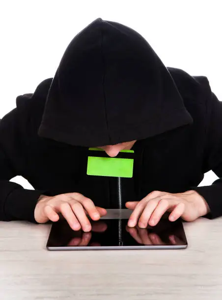 Hacker with a Bank Card on the White Background