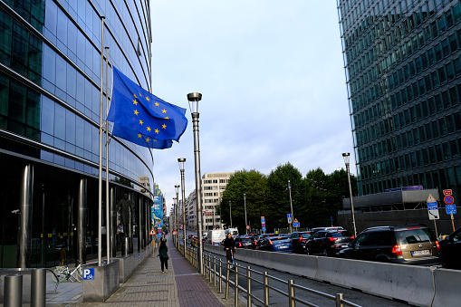 Three EU Flags in front of the European Union Commission building in Brussels, Belgium