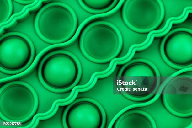 Relief Surface Of Green Silicon Anti Stress Sensory Pop It Toy With With Bumps And Pits Close Up Stock Photo - Download Image Now