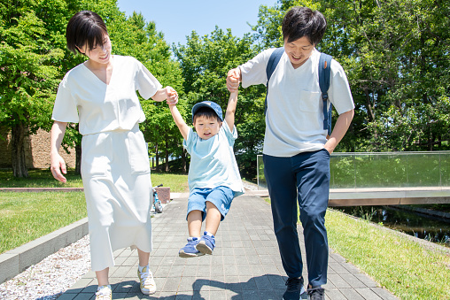 Japanese family holding hands while walking