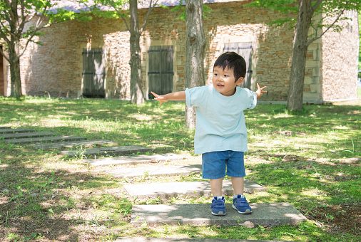 Japanese boy playing in a park full of nature