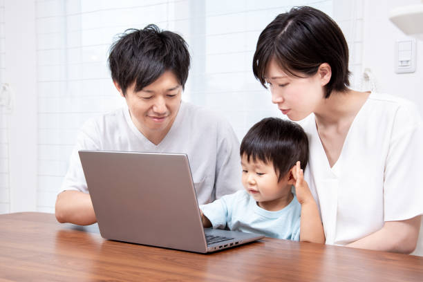 istock Japanese family making a travel reservation on a computer 1422222718