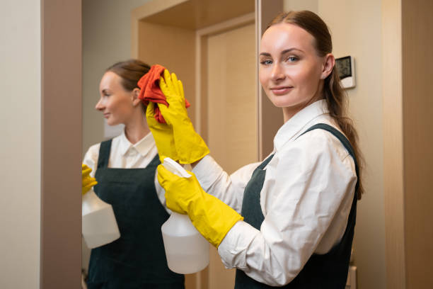 istock Maid cleans mirror in hotel bathroom spraying detergent 1422222983