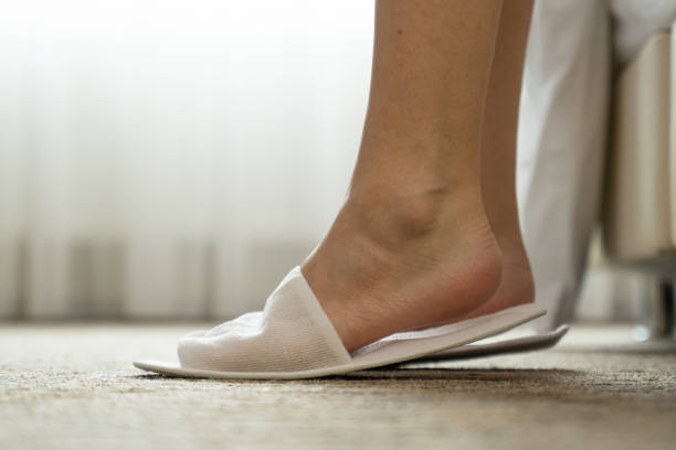 white house slipper isolated over mat background. slippers from hotel