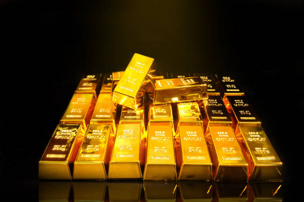 istock Gold bars and coins on black background 1422225390