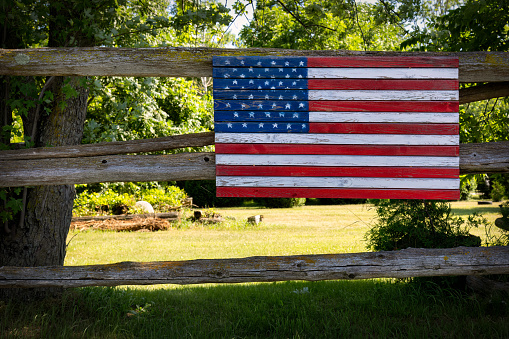 A wooden American flag attached to a fence by the village of Cato near Manitowoc, Wisconsin.