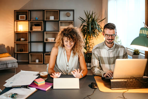 istock Man and woman working together at home 1422229137