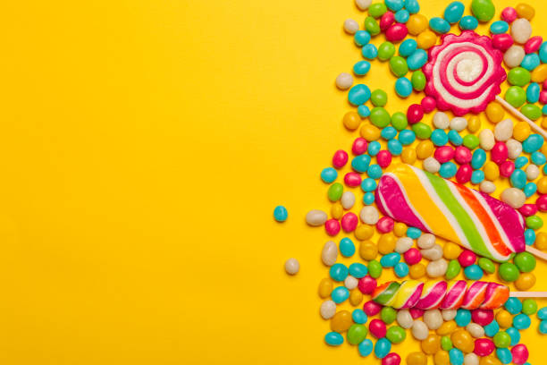 istock colored candies on yellow background 1422234078