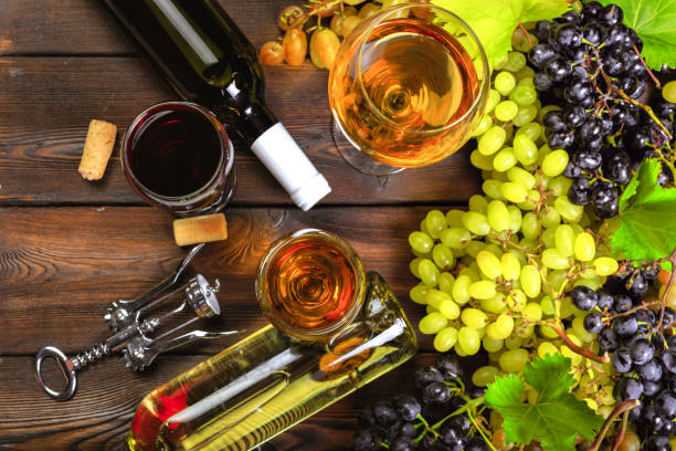 istock wine with branches of white grapes. On a wooden table. 1422234163