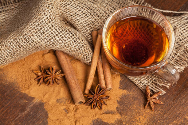 istock Cup with aromatic hot cinnamon tea on wooden table 1422234193