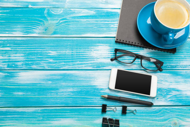 istock Modern workplace with cup of coffee on wooden table 1422234249