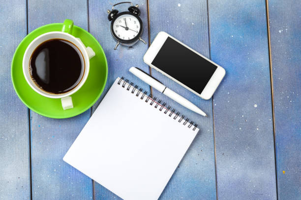 Modern workplace with cup of coffee on wooden table