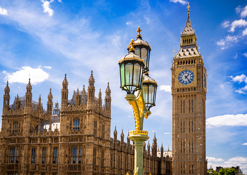London Big Ben clock tower in Westminster in a summer sunny blue sky day with streetlights detail