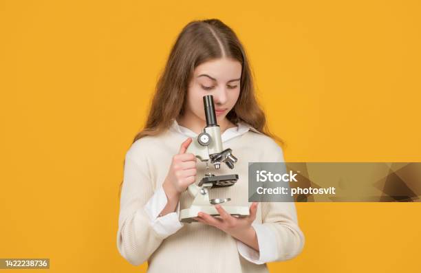 Serious Child With Microscope On Yellow Background Stock Photo - Download Image Now - Science, Teenager, Back to School
