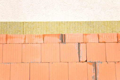 Surface of a yellow brick wall.