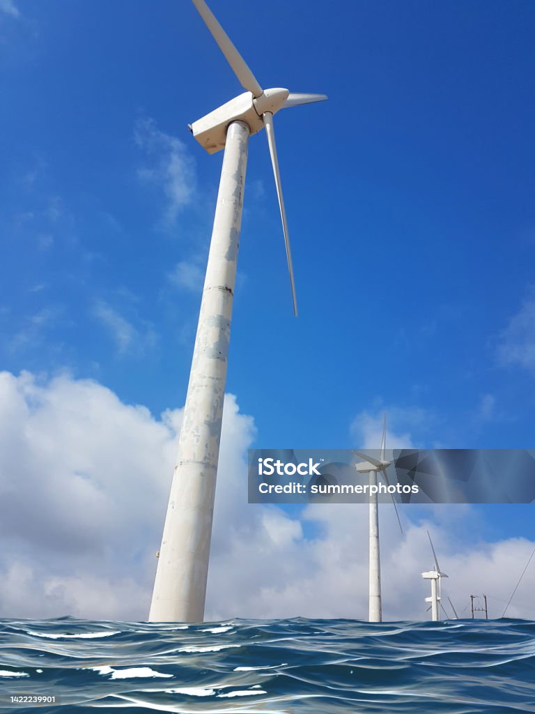 wind-energy park wind generators in andros island greece wind wind-energy sea water park wind generators blue sky and clouds Sea Stock Photo