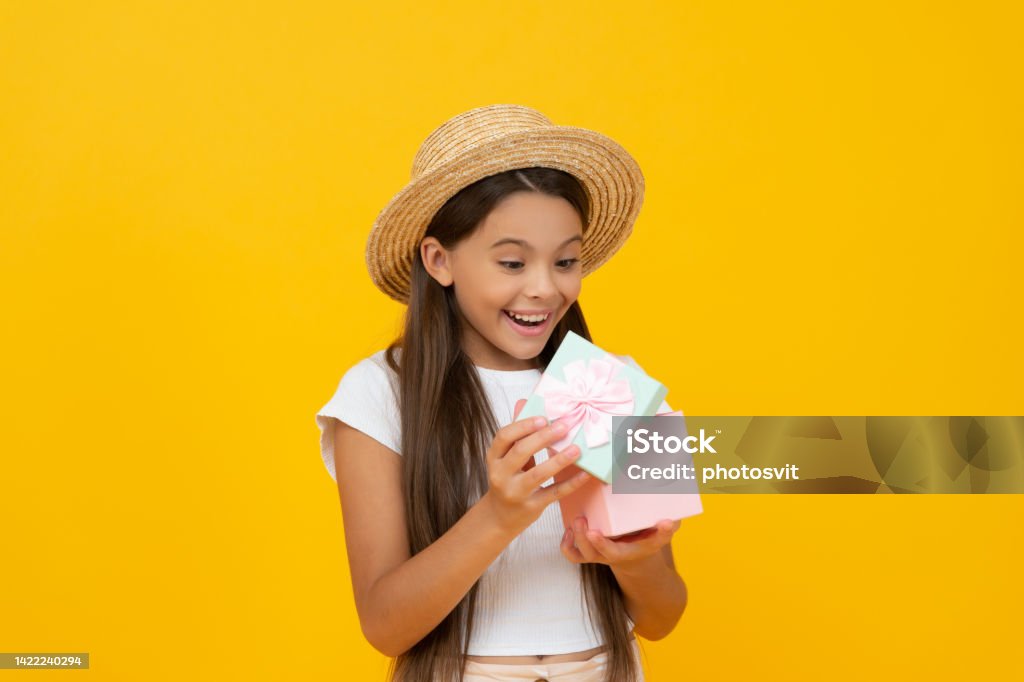 shocked teen kid hold present box on yellow background shocked teen kid hold present box on yellow background. Advertisement Stock Photo