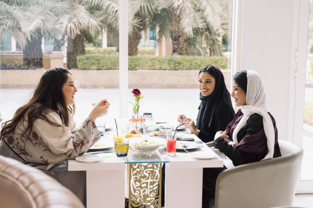 Smiling young Saudi women lunching at Riyadh restaurant stock photo