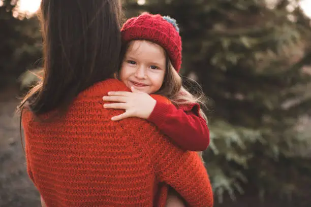 Photo of Smiling child girl with mother outdoor