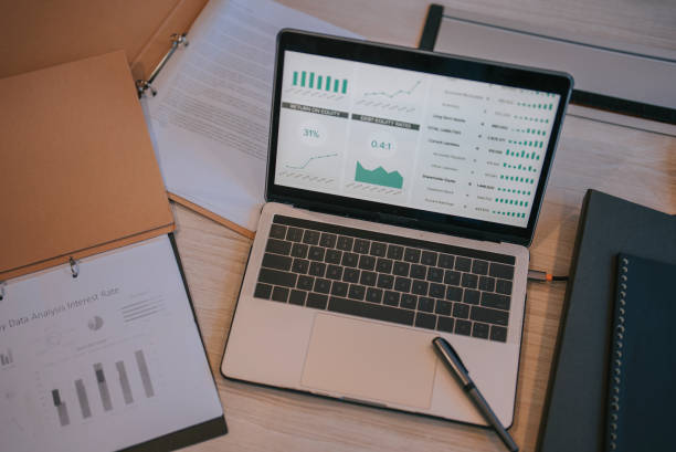 workplace with laptop and pen, documents files in meeting room conference table
