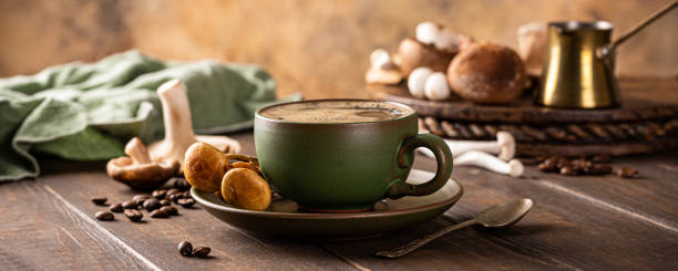 banner con café de setas en taza verde sobre fondo de madera. nuevo concepto saludable de moda superalimento con espacio de copia, enfoque selectivo. - basidiomycota fotografías e imágenes de stock