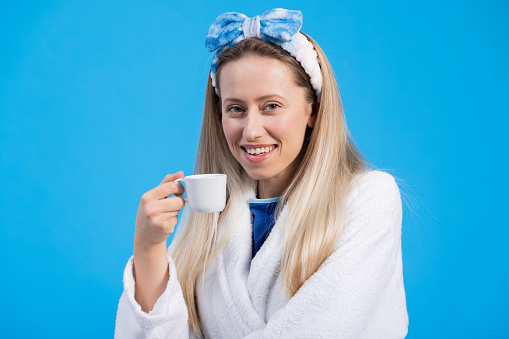 Woman Having a Cup of Coffee/Studio Shot