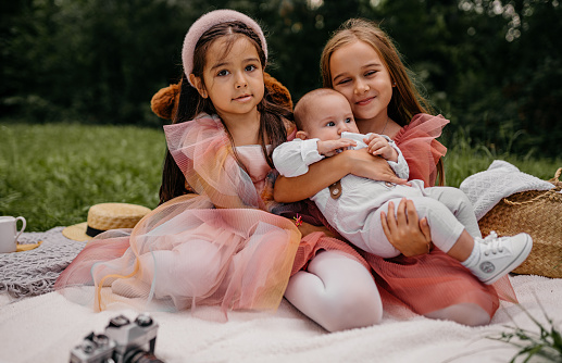 Baby and sisters on a picnic