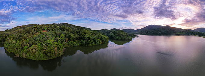 Aerial view drone shot of panorama abundant rainforest Sunset or sunrise sky over lake,Beautiful landscape nature mountains view in phuket thailand