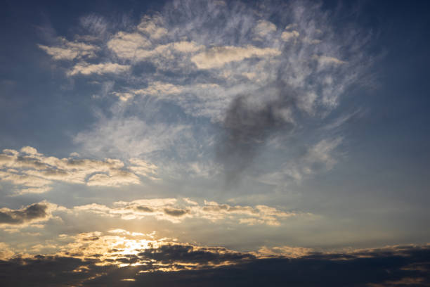 istock Scenery against a cloudy background with yellow sunlight passing through the blue sky. 1422252276