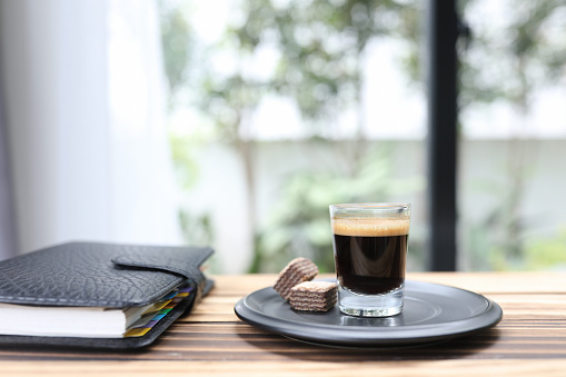 Coffee mug and waffle and notebook
