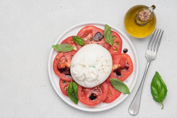istock Tomato salad with buratta cheese or mozzarella and basil 1422266902