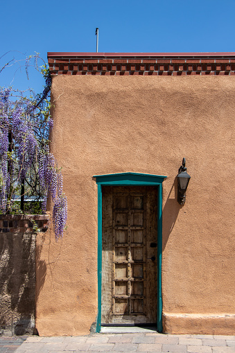 An old wooden door on an adobe style building in New Mexico