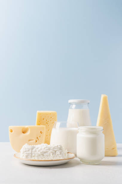 Variety of dairy products on blue background Bottle of milk, cheese,  yogurt or sour cream, cottage cheese. Farm dairy products concept dairy farm stock pictures, royalty-free photos & images