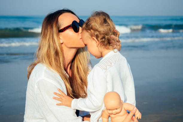 daughter and mother sunbathing on the beach