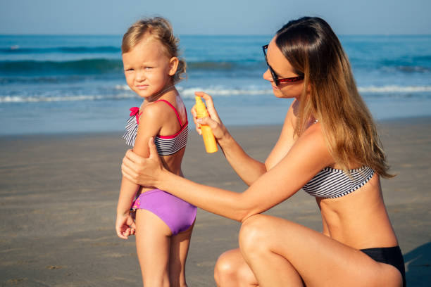 istock mother is putting on her back a sunscreen on the beach 1422271260