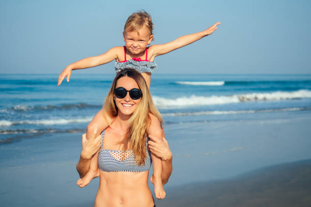 istock mother daughter having fun resting on the beach 1422271343