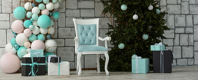 Christmas photo zone. Arch from a Christmas tree, balls, garlands, New Year's decorations. Gift boxes, empty blue chair