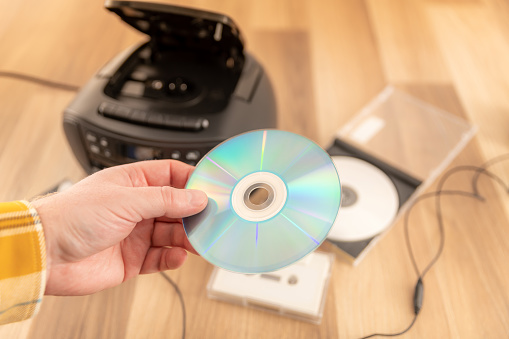Holding a compact disc (CD)